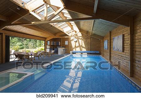 Stock Image - Indoor swimming pool under skylight. Fotosearch