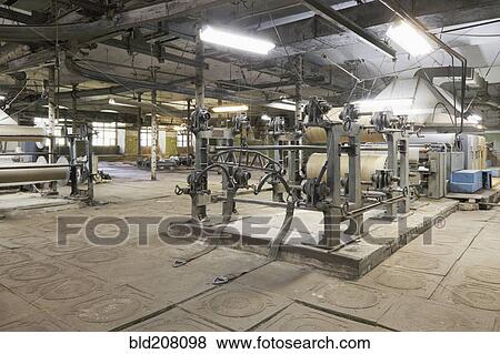 Industrial looms in textile factory View Large Photo Image Stock Photo - Industrial looms in textile factory. Fotosearch