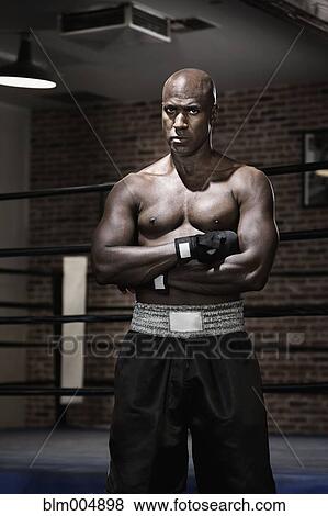 Intense African boxer with arms crossed View Large Photo Image Stock Photo - Intense African boxer with arms crossed. Fotosearch