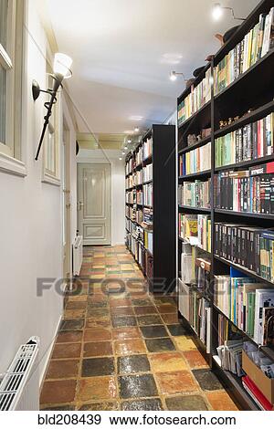 Stock Photo - Interior of an empty library with rows of books on a shelf. Fotosearch