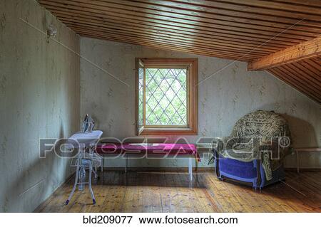 Ironing board, table and armchair in attic View Large Photo Image Stock Photo - Ironing board, table and armchair in attic. Fotosearch