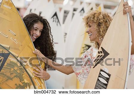 Israeli mother and daughter looking at surfboards View Large Photo Image Stock Image - Israeli mother and daughter looking at surfboards. Fotosearch