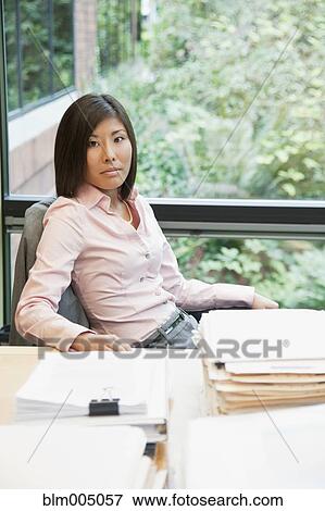 Japanese businesswoman working at desk View Large Photo Image Stock Photo - Japanese businesswoman working at desk. Fotosearch