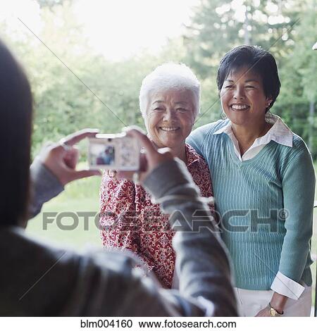 Japanese girl taking photograph of mother and grandmother View Large Photo Image Stock Image - Japanese girl taking photograph of mother and grandmother. Fotosearch