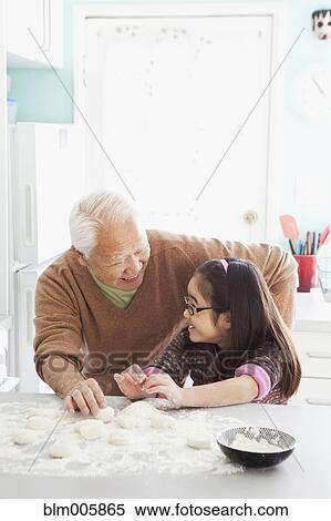 Stock Photography - Japanese grandfather and granddaughter baking. Fotosearch
