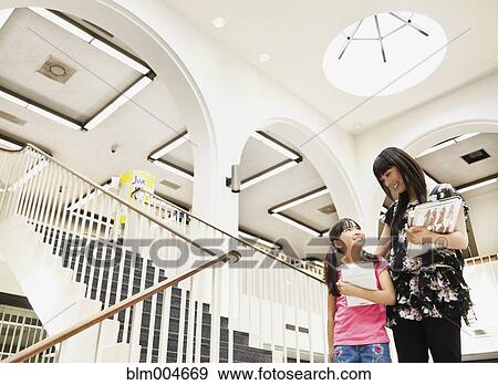 Stock Photo - Japanese mother and daughter in library. Fotosearch