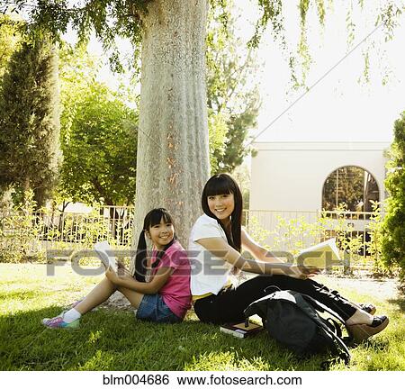 Japanese mother and daughter reading in park View Large Photo Image Stock Photograph - Japanese mother and daughter reading in park. Fotosearch