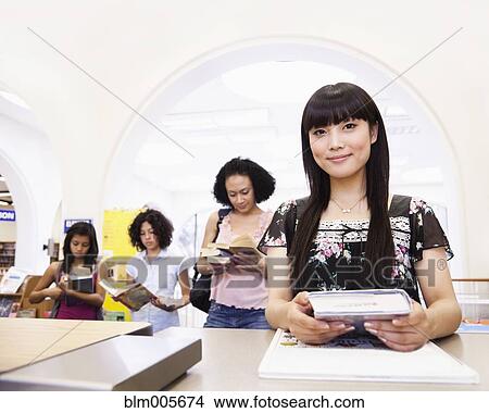Japanese woman checking out books from library View Large Photo Image Picture - Japanese woman checking out books from library. Fotosearch