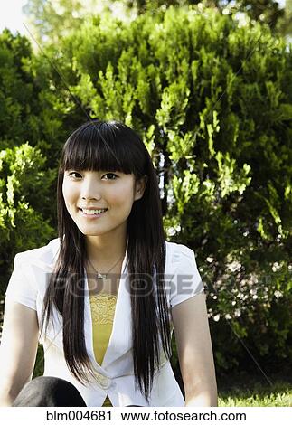 Japanese woman smiling in park View Large Photo Image Stock Image - Japanese woman smiling in park. Fotosearch