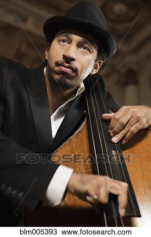 Stock Image - Jazz musician performing in nightclub. Fotosearch