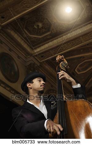 Jazz musician performing in nightclub View Large Photo Image Stock Image - Jazz musician performing in nightclub. Fotosearch