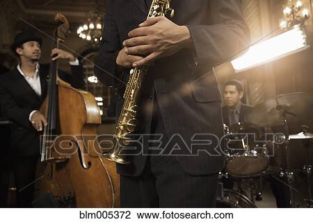Stock Image - Jazz musicians performing in nightclub. Fotosearch