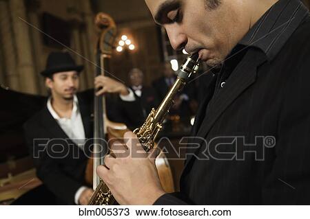 Stock Image - Jazz musicians performing in nightclub. Fotosearch