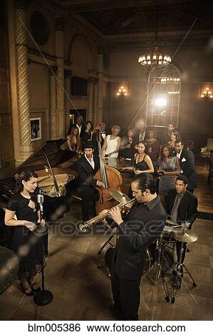Stock Photograph - Jazz musicians performing in nightclub. Fotosearch