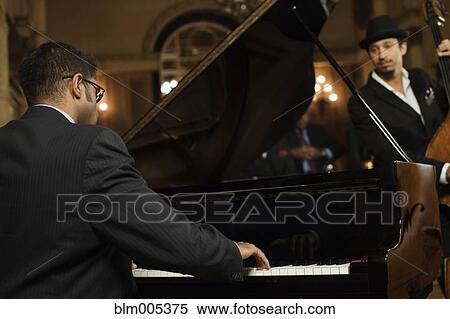Stock Photography - Jazz musicians performing in nightclub. Fotosearch