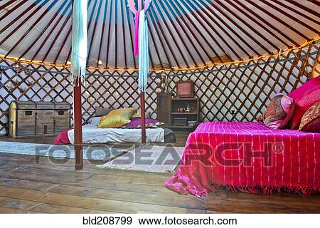Stock Photo - King sized double bed in a luxurious traditional Mongolia yurt. Fotosearch