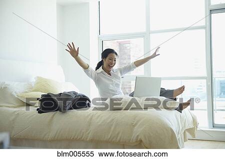 Korean businesswoman working and cheering in hotel room View Large Photo Image Stock Photography - Korean businesswoman working and cheering in hotel room. Fotosearch
