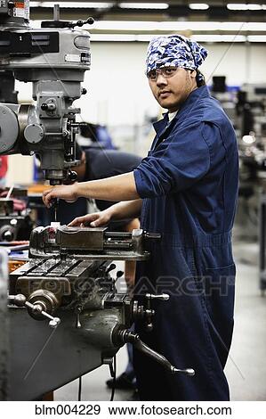 Korean man using machine in machine shop View Large Photo Image Stock Photo - Korean man using machine in machine shop. Fotosearch
