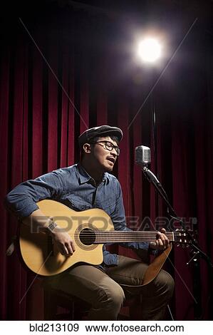 Stock Photo - Korean singer performing on stage. Fotosearch