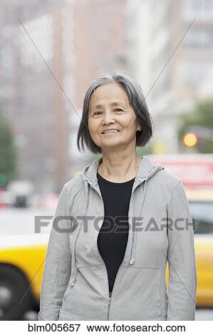 Korean woman on urban street View Large Photo Image Stock Photo - Korean woman on urban street. Fotosearch
