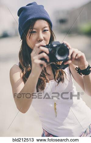 Korean woman taking pictures on city street View Large Photo Image Stock Image - Korean woman taking pictures on city street. Fotosearch