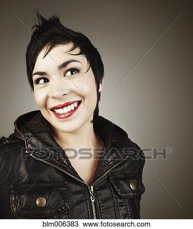 Stock Image - Latin American woman wearing leather jacket. Fotosearch