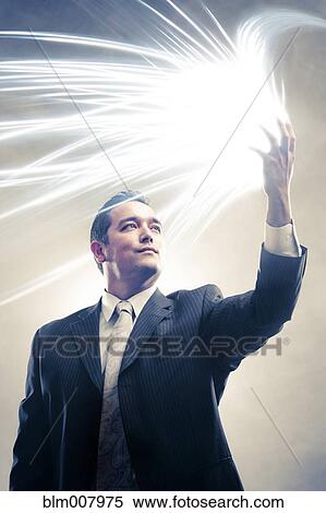 Light radiating from Japanese businessman's hands View Large Photo Image Stock Photography - Light radiating from Japanese businessman's hands. Fotosearch