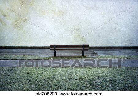 Stock Image - Lone park bench in Stanley Park, Vancouver, BC, Canada. Fotosearch