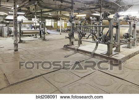 Stock Image - Looms and equipment in textile factory. Fotosearch