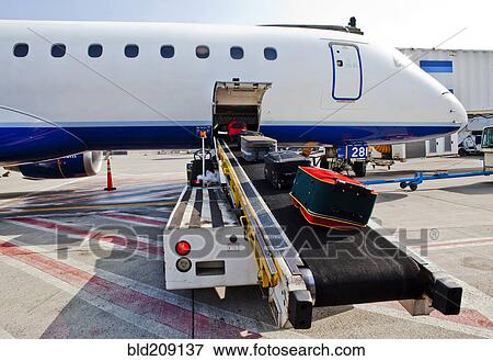 Luggage on conveyor belt by airplane cargo hold View Large Photo Image Stock Photo - Luggage on conveyor belt by airplane cargo hold. Fotosearch