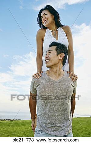 Man carrying girlfriend in rural landscape View Large Photo Image Stock Photo - Man carrying girlfriend in rural landscape. Fotosearch