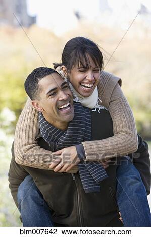 Man giving girlfriend piggyback ride View Large Photo Image Stock Image - Man giving girlfriend piggyback ride. Fotosearch