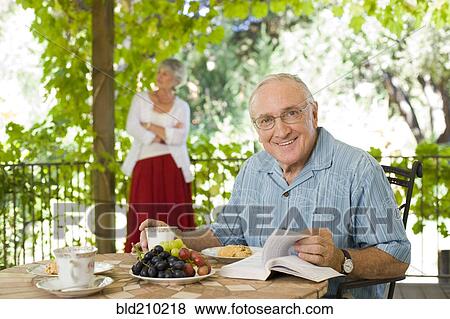 Man having breakfast outdoors View Large Photo Image Stock Photo - Man having breakfast outdoors. Fotosearch