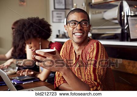 Stock Image - Man having cup of coffee in cafe. Fotosearch