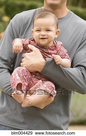 Stock Photo - Man holding baby girl. Fotosearch