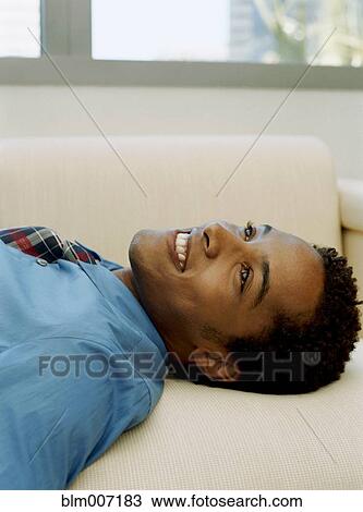 Stock Image - Man laying down. Fotosearch