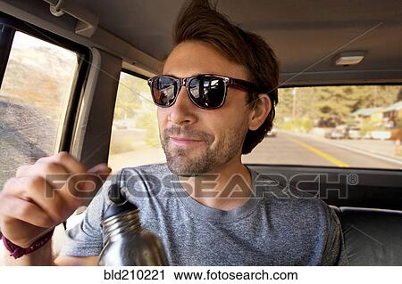 Man sitting in car View Large Photo Image Stock Image - Man sitting in car. Fotosearch