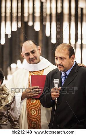 Stock Photo - Man speaking at traditional wedding. Fotosearch