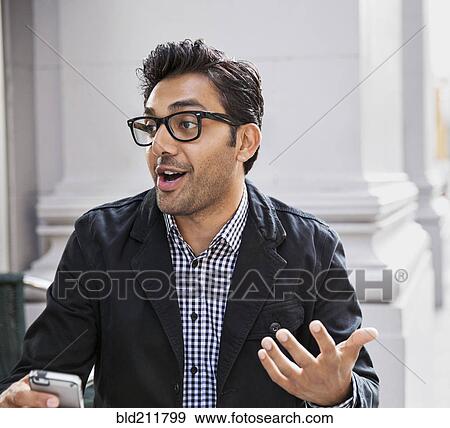 Stock Photo - Man talking at sidewalk cafe. Fotosearch