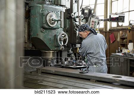 Man using machinery in metal shop View Large Photo Image Stock Image - Man using machinery in metal shop. Fotosearch