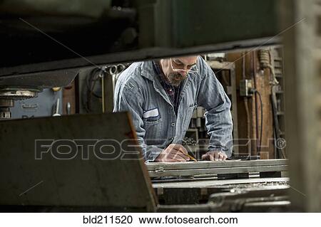 Man working in metal shop View Large Photo Image Stock Image - Man working in metal shop. Fotosearch