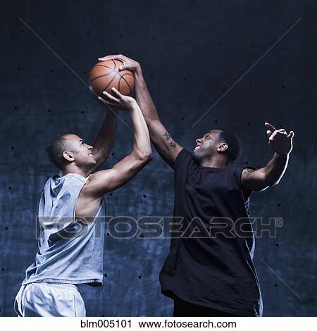 Stock Image - Men playing basketball. Fotosearch