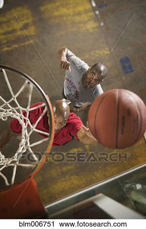Stock Image - Men playing basketball. Fotosearch