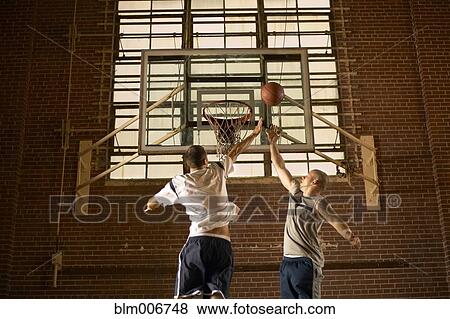 Stock Photo - Men playing basketball. Fotosearch