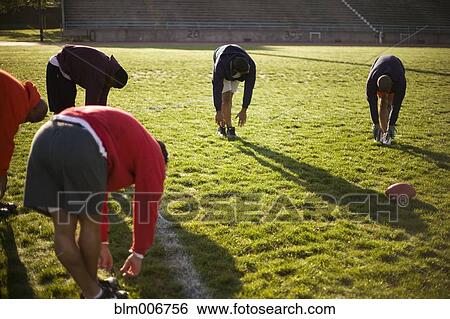 Men training on football field View Large Photo Image Stock Photograph - Men training on football field. Fotosearch