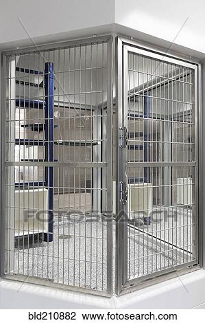 Stock Image - Metal doors of empty cage in animal shelter. Fotosearch
