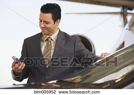 Middle Eastern businessman text messaging on cell phone View Large Photo Image Stock Image - Middle Eastern businessman text messaging on cell phone. Fotosearch