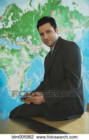 Middle Eastern businessman text messaging with cell phone View Large Photo Image Stock Image - Middle Eastern businessman text messaging with cell phone. Fotosearch
