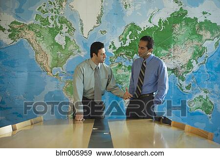 Stock Photo - Middle Eastern businessmen talking in conference room. Fotosearch