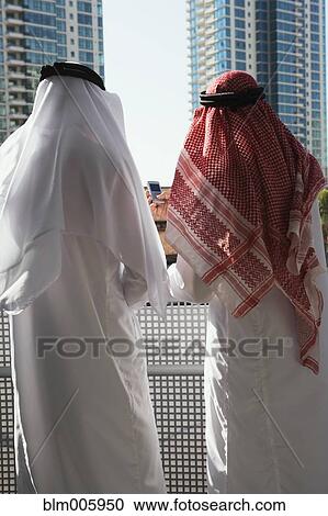 Middle Eastern man in traditional clothing looking at highrise View Large Photo Image Stock Image - Middle Eastern man in traditional clothing looking at highrise. Fotosearch
